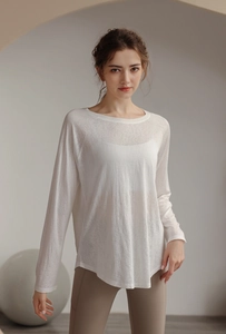 Close-up of lightweight semi-transparent white long sleeve yoga top with curved hemline
