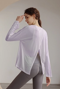 Detail view of lavender long-sleeved sports top with unique back cross split design