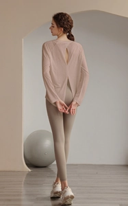 Detail view of pink yoga top showing back cutout and high-waist yoga leggings