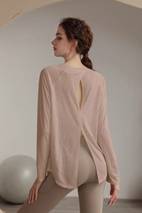 Macro detail of breathable rose pink yoga shirt featuring an open back slit design