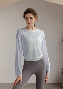 Detail of white semi-transparent long-sleeve sports top with a round neck and breathable fabric