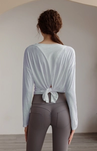 Detail view of Tencel sports top with open back tie-up design and high waist yoga leggings