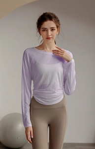 Detail of light purple yoga top featuring side ruching and breathable Tencel fabric