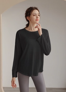 Close-up of a loose-fit black yoga top featuring breathable Tencel fabric and a smooth drape