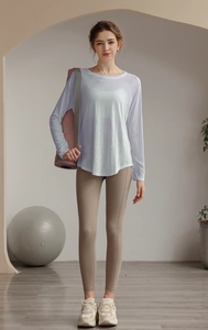 Tencel mesh yoga top with long sleeves over a sports bra for pilates training gear