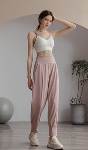 Women's ultra-high waist joggers in lotus pink paired with a white sports bra and sneakers