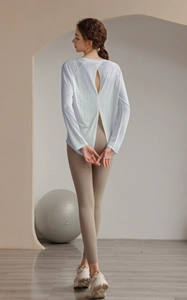 Detailed back view of white long sleeve yoga top with open split back design