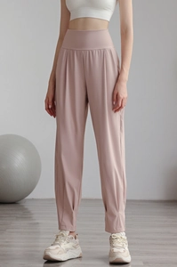 Detail of high-waisted nylon joggers showing slimming fit and elastic yoga fabric