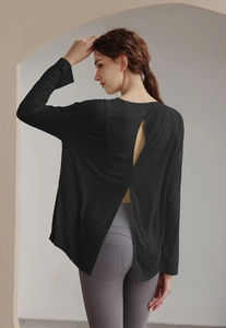 Detail of loose black long sleeve yoga cover-up with stylish open back cutout design