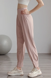 Detailed side view of high-waist pink joggers featuring side pockets and tapered cuffs