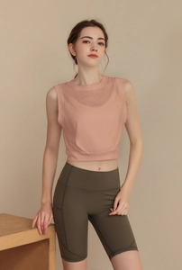 Detail of high-waist olive green biker shorts with functional side phone pocket and seams