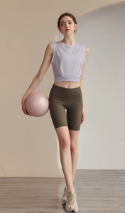 Close-up of lilac cropped workout vest and olive green biker shorts with side pockets