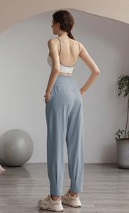 Detail view of high-waist light blue yoga jogger pants with elastic cuffs for women