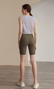 Detail view of racerback lavender workout tank top and green high-waist yoga shorts