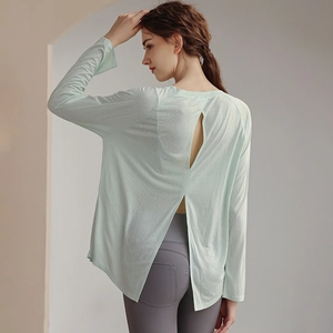 Light green long-sleeved yoga cover-up shirt with an open-back design for women