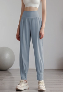 Detail of high-waisted pale blue yoga joggers with cinched ankles and pleated texture