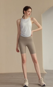 Detail of white nylon jacquard yoga tank top with mesh back and high-waist biker shorts