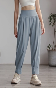Detail of high-waist yoga joggers in grey-blue nylon with a relaxed fit and elastic cuffs