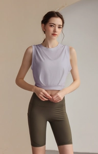 Detailed close-up of lavender sleeveless sports top and olive green cycling shorts fabric