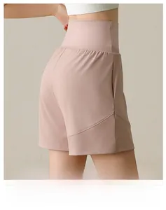 Detail view of high-waisted pink sports shorts with side pockets and smooth athletic fabric