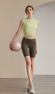 Close-up of lightweight yellow-green sleeveless sports tank top and olive green biker shorts