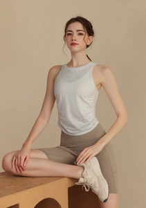 Detailed texture of white jacquard yoga vest showing breathable mesh and slim fit fabric