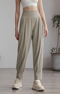 Close-up of high-waisted nylon jogger pants in sage green with soft matte texture