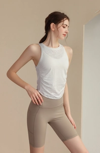 Close-up of slim-fit jacquard yoga vest with side drawstring detail and textured fabric