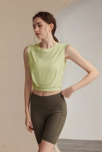 Detail of light green sleeveless sports vest and olive high-waist yoga shorts set