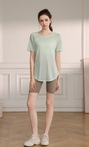 Detail of mint green breathable yoga tee with side slit and curved hem for women