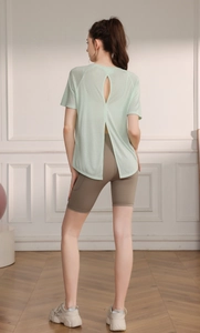 Detail view of the open-back split design on this breathable green yoga t-shirt