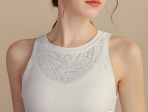 Detail of white jacquard yoga vest showing breathable mesh cutouts and neckline