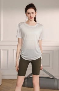 Detail of white yoga t-shirt with side drawstring and dark green high waist shorts