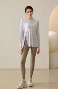 Detail of the high-slit hem on a lavender long sleeve yoga top with breathable fabric