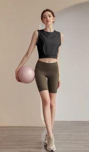 Close-up of olive green high-waisted fitness shorts with functional side pocket detail