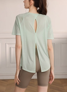 Detail of light green quick-dry yoga top featuring back cutout and side split hem design