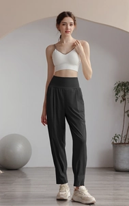 Detail of high waisted black nylon yoga pants with wide tummy control waistband