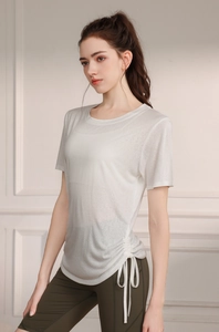 Detail view of white yoga t-shirt featuring adjustable side drawstring and ruched texture