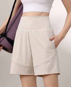 Detail of high-waisted loose fitness shorts with side pockets and breathable nylon fabric