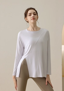Detail of white yoga long sleeve top with unique side split design and relaxed fit