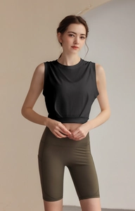 Detailed shot of breathable crop top hem and high waist olive green cycling shorts