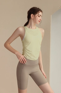 Detail of light green jacquard yoga vest fabric and taupe biker shorts with side pockets