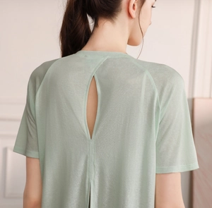 Close-up of lightweight light green yoga top featuring breathable back teardrop cutout detail