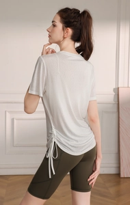 Detail of the white translucent yoga top with adjustable drawstring and side pocket shorts