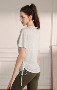 Close-up of the white yoga t-shirt fabric texture with side drawstring detail