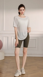 Breathable white yoga T-shirt paired with olive green high-waisted cycling shorts