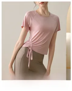 Detail view of pink yoga T-shirt with adjustable side drawstring for fitness training