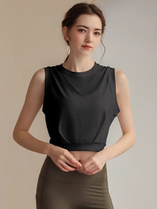Women's loose sleeveless sports tank top with high-waisted olive yoga leggings