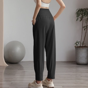 High-waisted black nylon sports joggers for women with side pockets and cinched cuffs