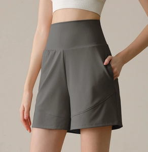 Close-up of high-waisted dark grey yoga shorts with side pockets and slimming curved seams